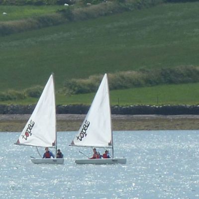 two sailing boats in Dingle Harbour with two people in each boat
